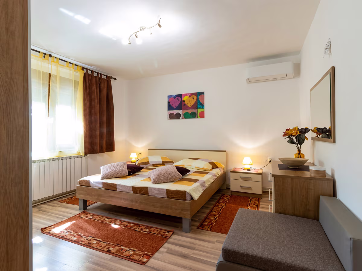 Contemporary guest bedroom with designer furniture and warm earth tones