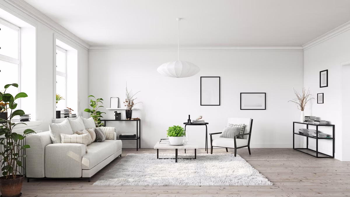 Minimalist white living room with sculptural pendant light and black accents