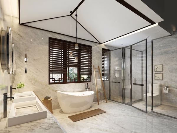 Luxury bathroom with vaulted ceiling, freestanding tub, wooden window screens, and marble surfaces