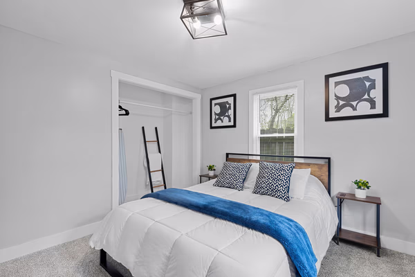 Modern minimalist master bedroom with industrial touches and blue color accents