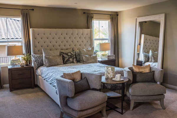 Transitional luxury bedroom with tufted headboard and neutral palette