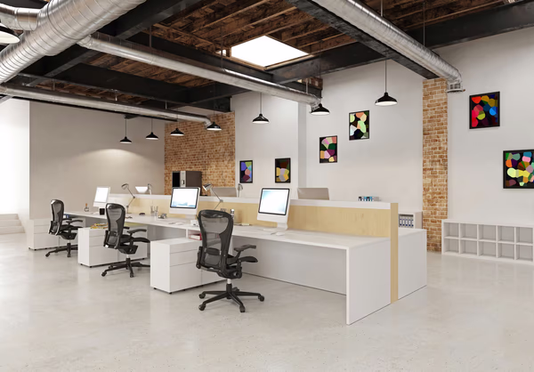 Creative open office with collaborative desks, vibrant decor, and industrial elements