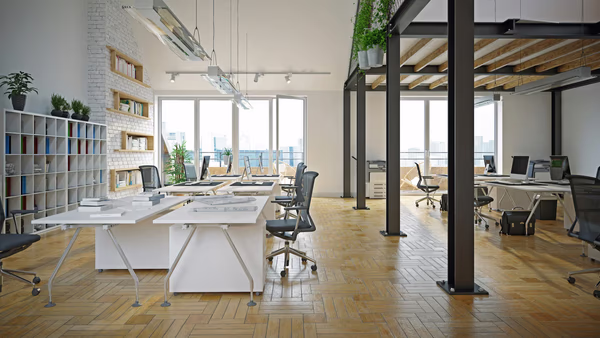 Eco-friendly loft office with modular desks, ergonomic chairs, and natural elements