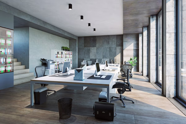 Sleek modern workspace with white desks, ergonomic chairs, and large windows