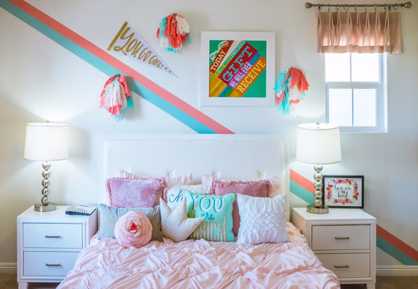 Teen girl bedroom with coral and turquoise diagonal stripe wall and decorative accents