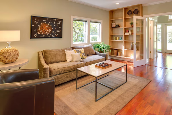 Contemporary living room with built-in shelving and oriental wall art
