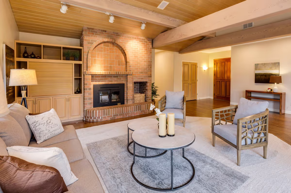 Rustic modern living room with brick fireplace and wooden ceiling