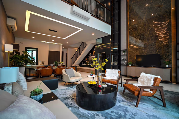 Luxury double-height living room with LED ceiling detail and marble accent wall