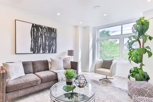 Contemporary living room with abstract artwork and velvet sofa