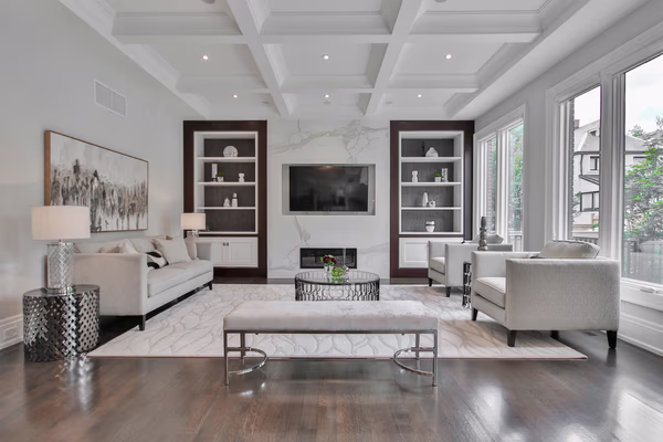 Luxury living room with coffered ceiling and custom built-in shelving